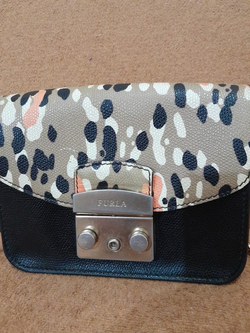 Furla Mini Crossbody Bag with Chain Strap (Category: Luxury Bags & Wallets) located in Quezon City. Submitted by lalaine.r (Listing ID 1459511473, Image 3). Description: - Cute Furla mini bag - Black and patterned leather - Gold chain strap - Gold-toned clasp closure - Small size, ideal for essentials - Perfect for nights out or traveling light - Signs of use in hardware.