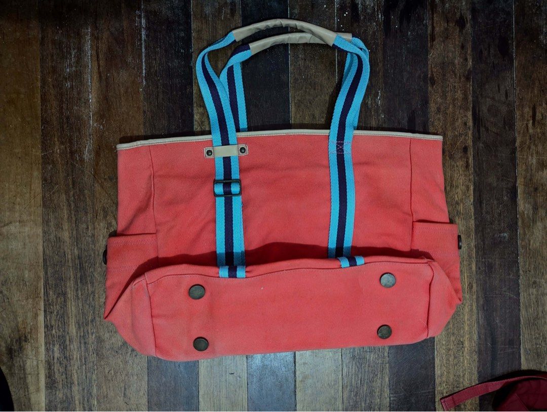 GAP Jeans Orange Canvas Tote Bag (Category: Tote Bags) located in Quezon City. Submitted by thegoodkarmaph (Listing ID 1459561759, Image 2). Description: - Brand: GAP Jeans - Color: Orange canvas - Straps: Blue and dark blue stripes with leather accents - Features: Side pockets, zippered main compartment - Interior: Pink fabric lining - Ideal for: Everyday use, travel.