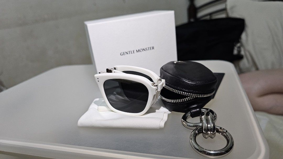 Gentle Monster White Sunglasses with Case and Box (Category: Sunglasses & Eyewear) located in Manila. Submitted by buyproperty (Listing ID 1459586205, Image 3). Description: - White Gentle Monster sunglasses - Comes with original box, black leather case, and cleaning cloth - Stylish and perfect for everyday wear - Ideal for sunny days out.