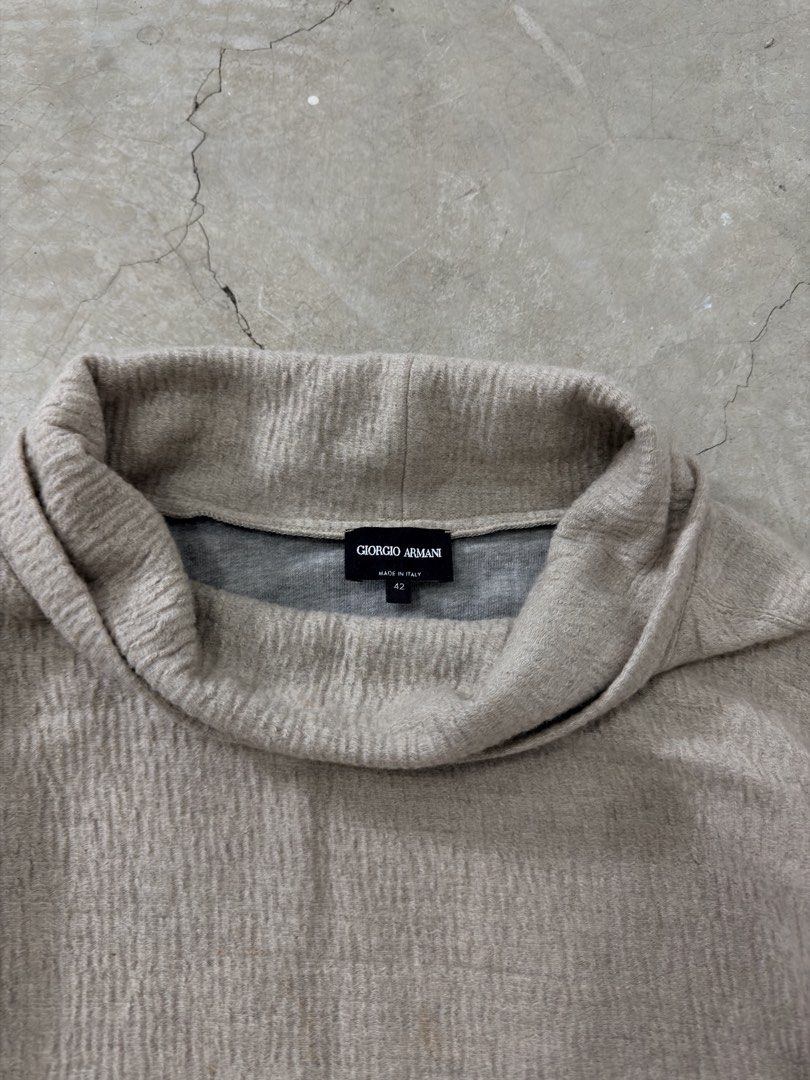 Giorgio Armani Turtleneck Top (Category: Sleeveless) located in Alfonso. Submitted by jbcamet (Listing ID 1459626337, Image 2). Description: - Lightweight Giorgio Armani turtleneck top - Beige textured fabric - Unique tie detail on the side - Three-quarter sleeves - Made in Italy - Size 42.