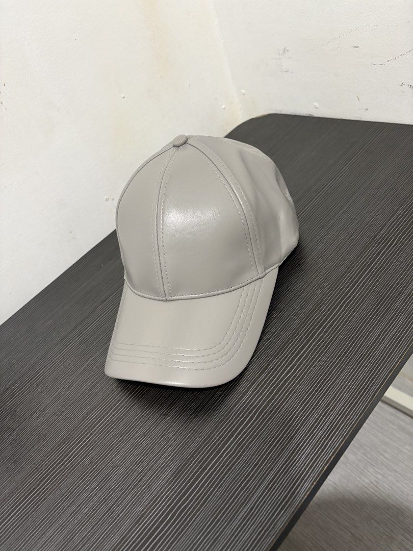 Grey Faux Leather Baseball Cap (Category: Caps & Hats) located in Quezon City. Submitted by batch. (Listing ID 1459627846, Image 1). Description: 6 panels and adjustable Never been used. Color and condition 10/10 Free shipping.
