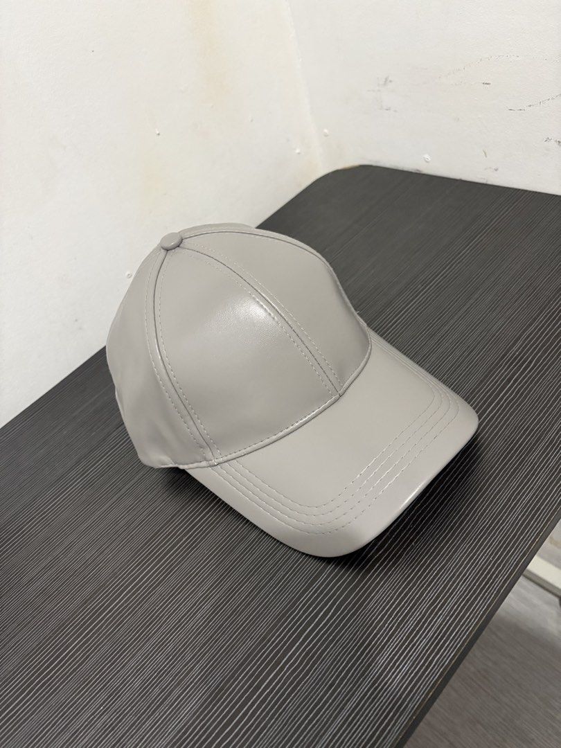 Grey Faux Leather Baseball Cap (Category: Caps & Hats) located in Quezon City. Submitted by batch. (Listing ID 1459627846, Image 2). Description: 6 panels and adjustable Never been used. Color and condition 10/10 Free shipping.