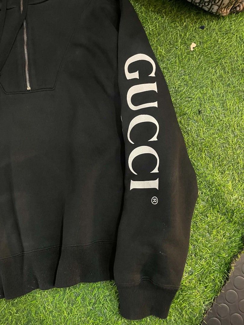 Gucci Black Half Zip Hoodie (Category: Coats, Jackets and Outerwear) located in Cainta. Submitted by mariss.luxx (Listing ID 1459542132, Image 3). Description: - Authentic Black Gucci Hoodie - Half zip design - Iconic Gucci logo on sleeve - Features circular GG motif - Ribbed cuffs and hem for a snug fit - Adjustable drawstring hood - A great addition to any Gucci collection.