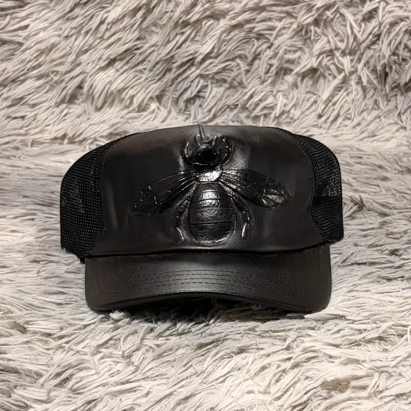 Gucci Black Leather Bee Trucker Cap (Category: Caps & Hats) located in Santa Rosa. Submitted by klarksantos (Listing ID 1459600845, Image 1). Description: - Authentic Gucci trucker cap - Iconic bee emblem on the front - Leather front panel - Breathable mesh back - Adjustable strap for a custom fit - Versatile accessory for any outfit.