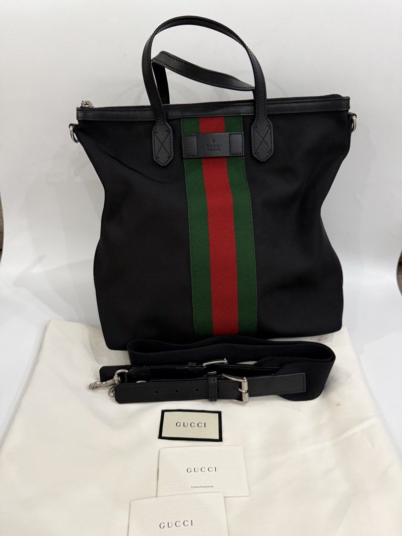 Gucci Canvas Web Vertical Tote /sling bag (Category: Luxury Bags & Wallets) located in Caloocan City. Submitted by krishazach (Listing ID 1459500446, Image 1). Description: - Authentic Gucci tote bag - Black canvas with signature green and red stripe - Leather handles and trim - Includes detachable shoulder strap - Comes with dust bag and paper bag .