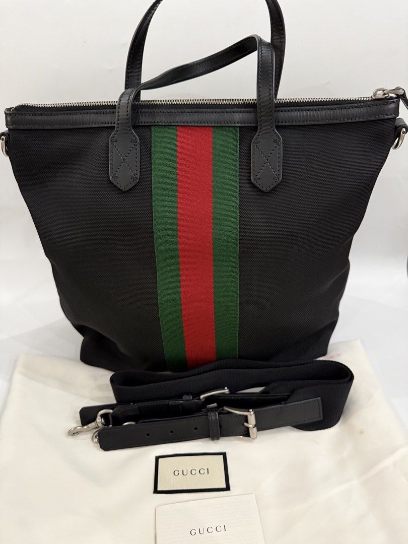 Gucci Canvas Web Vertical Tote /sling bag (Category: Luxury Bags & Wallets) located in Caloocan City. Submitted by krishazach (Listing ID 1459500446, Image 3). Description: - Authentic Gucci tote bag - Black canvas with signature green and red stripe - Leather handles and trim - Includes detachable shoulder strap - Comes with dust bag and paper bag .