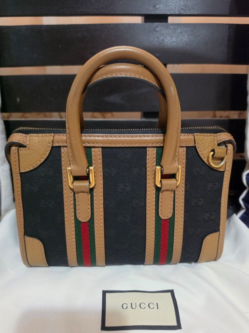 Gucci Mini Bauletto Top Handle Bag (Category: Luxury Bags & Wallets) located in Cavite. Submitted by kazi_preloved (Listing ID 1459548474, Image 2). Description: - 100% Authentic Gucci mini duffle bag - Iconic GG Supreme canvas with brown leather trim - Signature green and red web stripe - Detachable adjustable guitar strap and top handles - Gold-toned hardware - with dustbag.