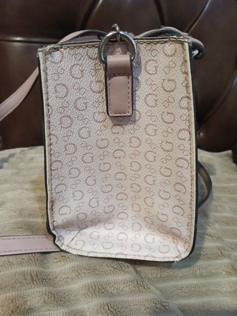 Guess Monogram Mini Handbag Shoulder Bag (Category: Luxury Bags & Wallets) located in Quezon City. Submitted by keycee_20 (Listing ID 1459623805, Image 2). Description: - Cute Guess mini handbag - Pink and beige monogram pattern - Top handles and long adjustable strap - Versatile wear: shoulder bag or crossbody - Multiple interior compartments for organization - Minor wear on handle attachments (please check photos for details).