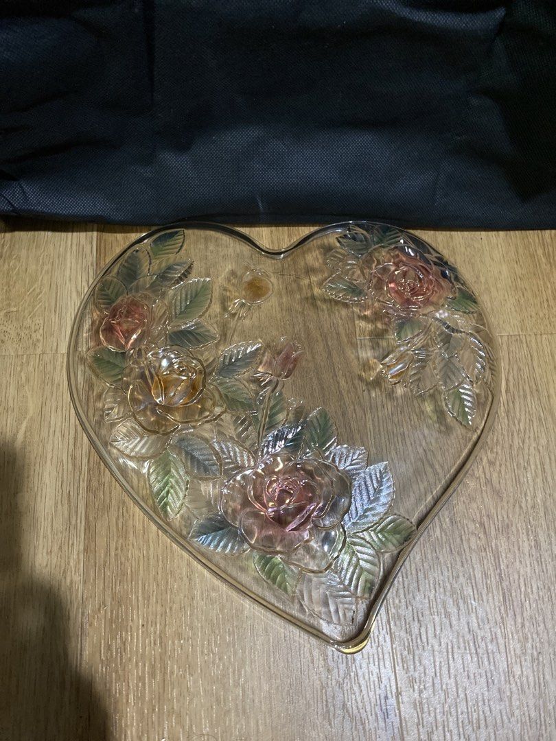 Heart-shaped glass dish with rose design (Category: Dinnerware & Cutlery) located in Taguig. Submitted by cosmickindle (Listing ID 1459570312, Image 2). Description: - Heart-shaped glass dish - Features embossed roses and leaves - Subtle iridescent sheen - Ideal for serving snacks or as a decorative piece - No chips or cracks observed - Slightly negotiable - RFS: Not in use **First to pay gets it.** **Please manage your expectations.**.