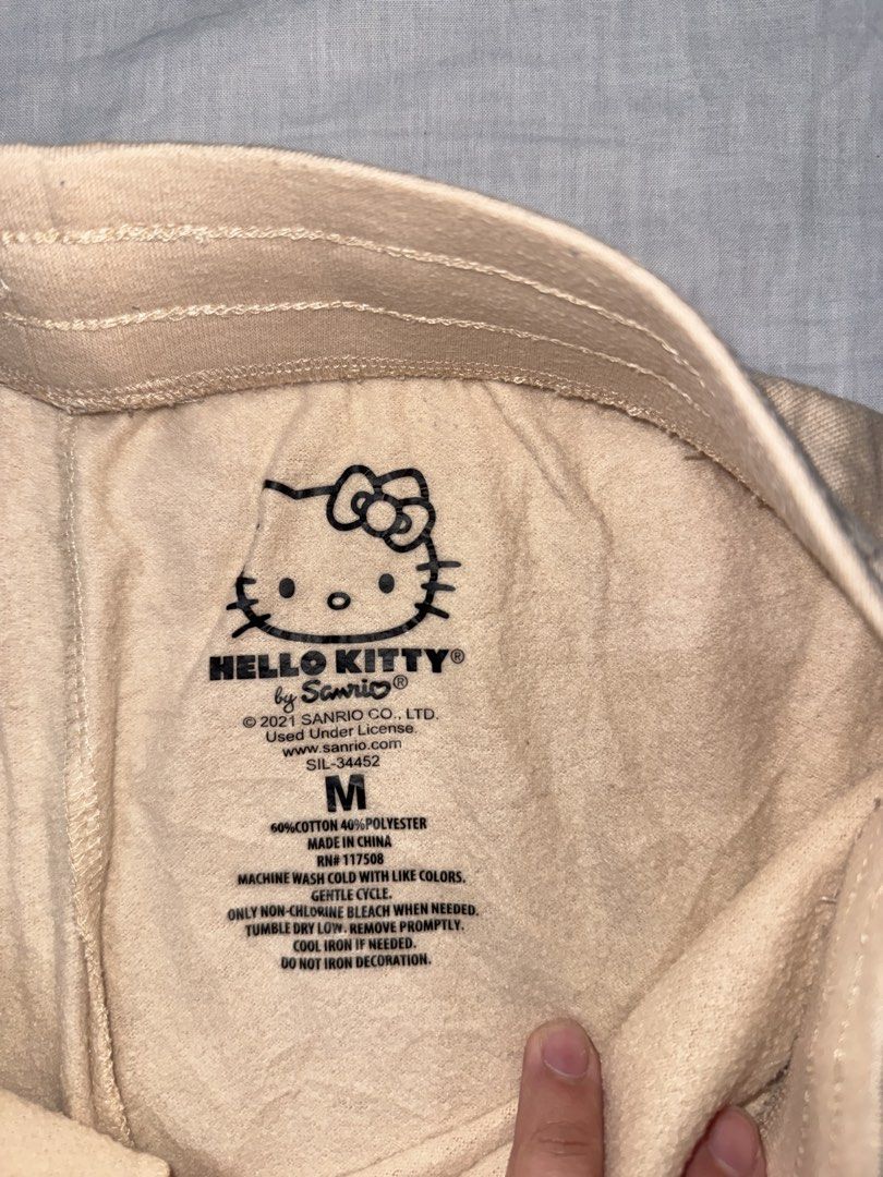 Hello Kitty by Sanrio Beige Sweat Shorts Size M (Category: Shorts) located in Santa Ana. Submitted by fatikilla (Listing ID 1459622121, Image 2). Description: - Adorable beige sweat shorts featuring a cute Kitty graphic. - Comfortable elastic waistband with an adjustable drawstring for a perfect fit. - Made from a soft and durable cotton-polyester blend. - Ideal for relaxing at home or for a casual, stylish look. - Genuine, officially licensed Sa