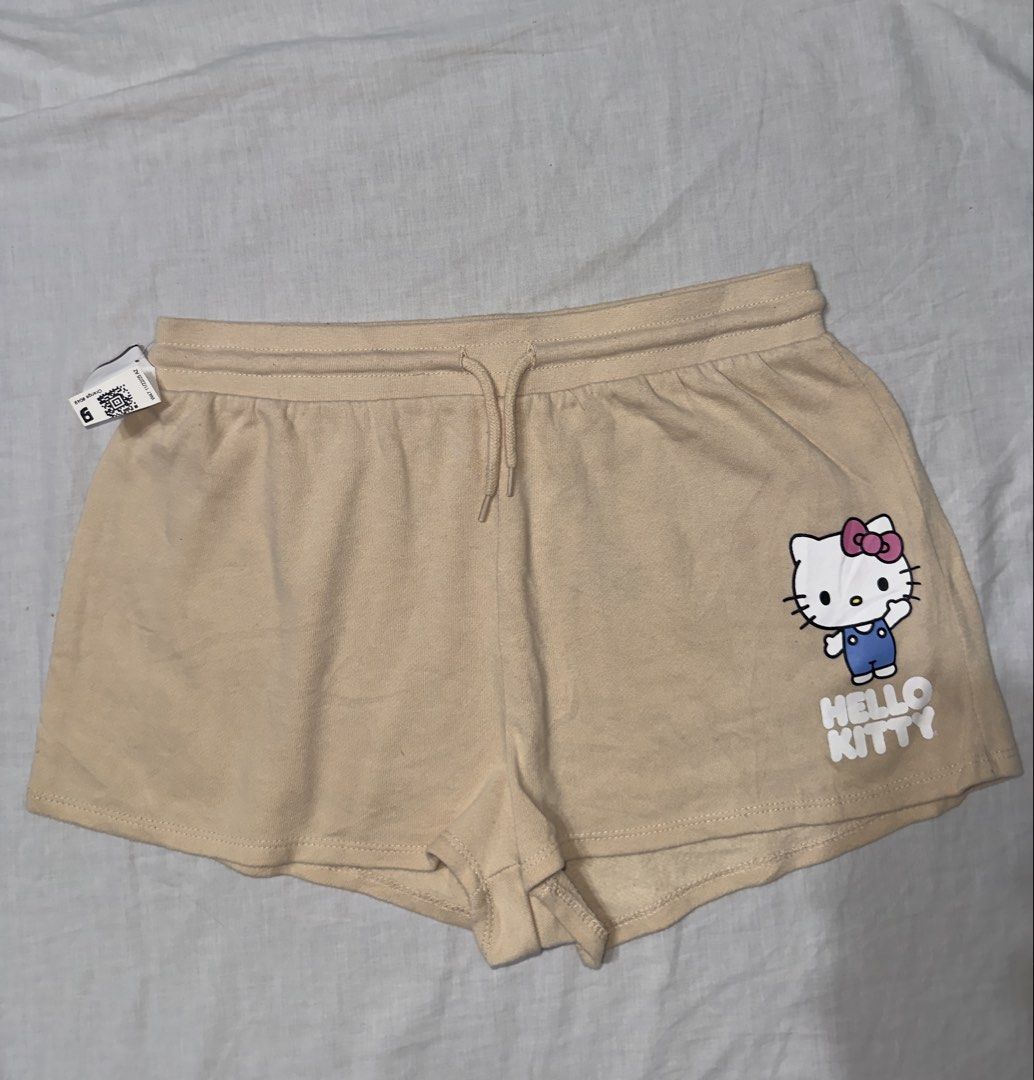 Hello Kitty by Sanrio Beige Sweat Shorts Size M (Category: Shorts) located in Santa Ana. Submitted by fatikilla (Listing ID 1459622121, Image 1). Description: - Adorable beige sweat shorts featuring a cute Kitty graphic. - Comfortable elastic waistband with an adjustable drawstring for a perfect fit. - Made from a soft and durable cotton-polyester blend. - Ideal for relaxing at home or for a casual, stylish look. - Genuine, officially licensed Sa