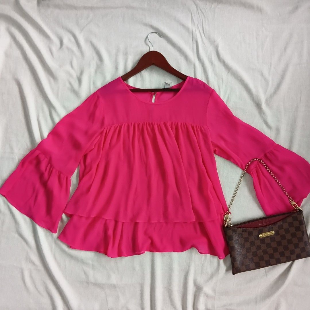 Hot Pink Bell Sleeve Blouse (Category: Blouses) located in Angeles City. Submitted by itsandspreloved (Listing ID 1459581334, Image 1). Description: - Cute hot pink blouse - Flowy bell sleeves - Gathered neckline detail - Pairs well with jeans or skirts - Ideal for night outs or special occasions - Comfortable and easy to wear.