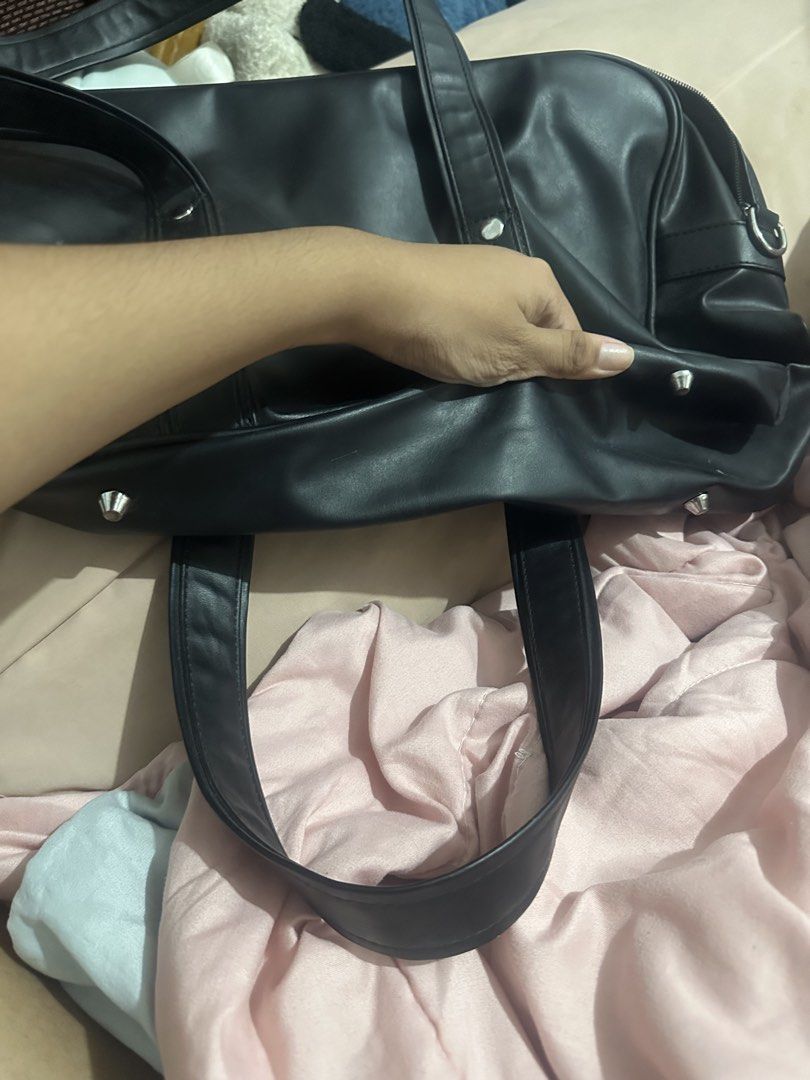 Japanese bag (Category: Shoulder Bags) located in Manila. Submitted by mayzee_ei (Listing ID 1459523370, Image 2). Description: - Black duffle bag - Faux leather material - Main compartment with inner pockets - Front pocket - Two handles - Detachable shoulder strap - Ideal for travel or gym.