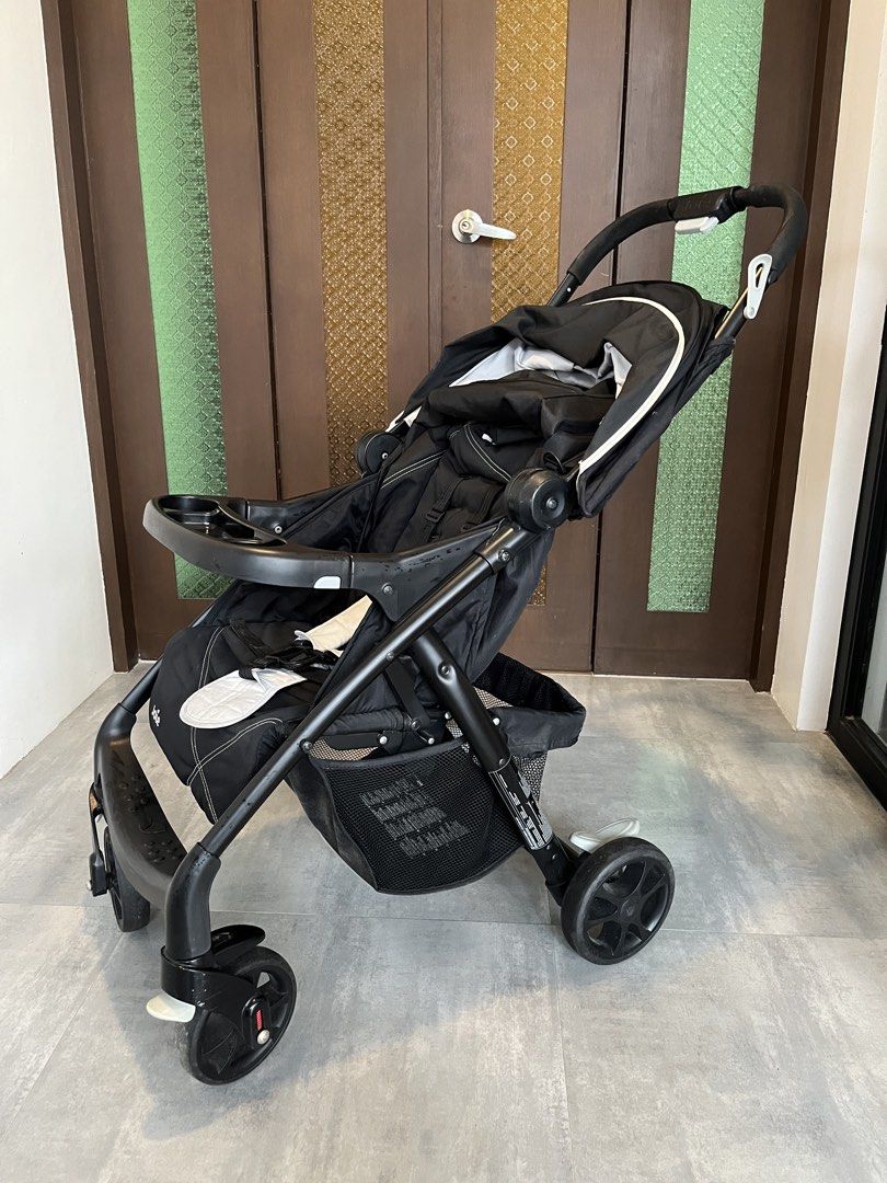 Joie Stroller (Category: Strollers) located in Paranaque City. Submitted by ideaofone (Listing ID 1459517573, Image 2). Description: - Black Joie stroller - Includes tray and under-seat basket - Padded harness for comfort - Sturdy wheels for smooth rides - Folds compactly for storage - Ideal for convenient travel with your child.
