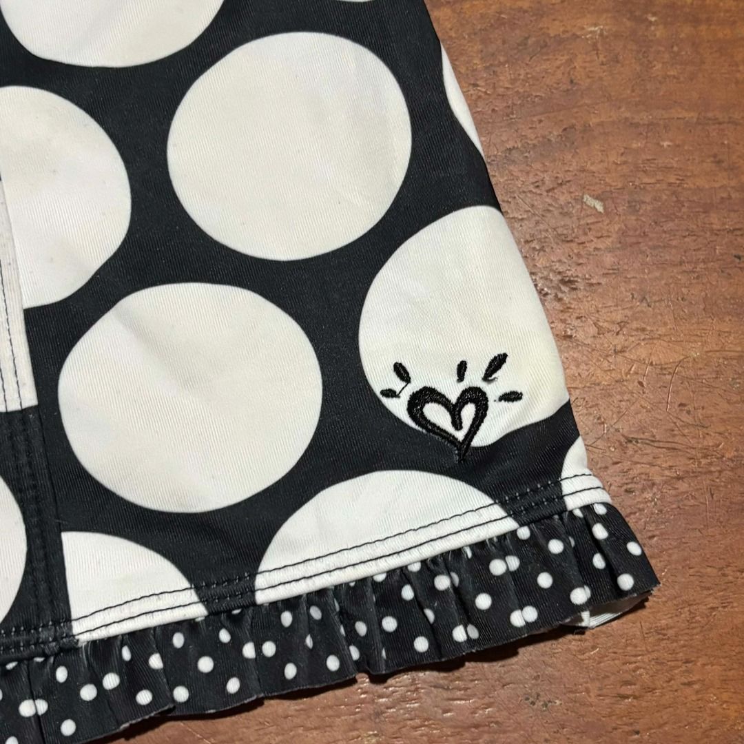 Justice Black White Polka Dot Swim Top (Category: Bikinis & Swimsuits) located in Iba. Submitted by fewiclo (Listing ID 1459557374, Image 2). Description: - Cute black and white polka dot pattern - Halter neck tie for adjustable fit - Ruffled hem detail for a feminine touch - Small heart logo accent on the side - Ideal for beach days or poolside lounging Size Small .