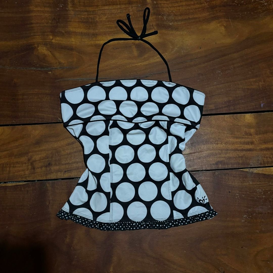 Justice Black White Polka Dot Swim Top (Category: Bikinis & Swimsuits) located in Iba. Submitted by fewiclo (Listing ID 1459557374, Image 1). Description: - Cute black and white polka dot pattern - Halter neck tie for adjustable fit - Ruffled hem detail for a feminine touch - Small heart logo accent on the side - Ideal for beach days or poolside lounging Size Small .
