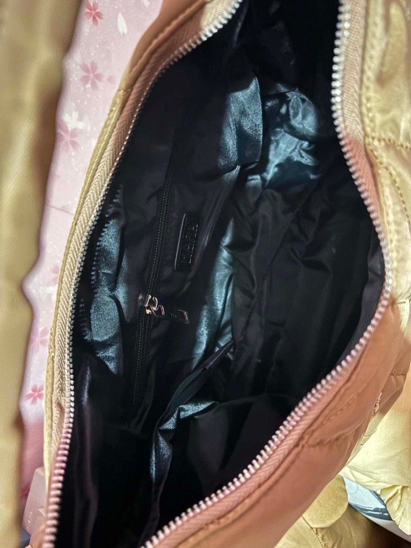 Karl Lagerfeld Quilted Nylon Shoulder Bag (Category: Luxury Bags & Wallets) located in Cavite. Submitted by mahthriftshop (Listing ID 1459620731, Image 3). Description: sale no last price before 1800 mop gcash plus sf - Brand: Karl Lagerfeld - Material: Quilted Nylon - Color: Tan - Closure: Zipper top - Exterior Features: Back zipper pocket - Interior Features: Zipper pocket, Slip pocket - Includes: Dust bag - Ideal for: Everyday use.
