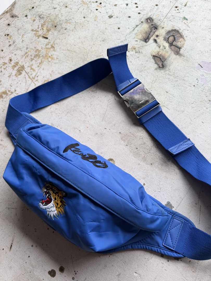 Kenzo Bag (Category: Cross-body Bags) located in Quezon City. Submitted by macleen17 (Listing ID 1459612947, Image 3). Description: Kenzo x Kansai Yamamoto Roaring Tiger Belt Bag in royal blue. It features the iconic embroidered roaring tiger motif on the front, script branding across the top flap, and an adjustable wide strap equipped with a polished silver-tone metal buckle. The bag is part of a capsule collection celebrating the legendary Japa