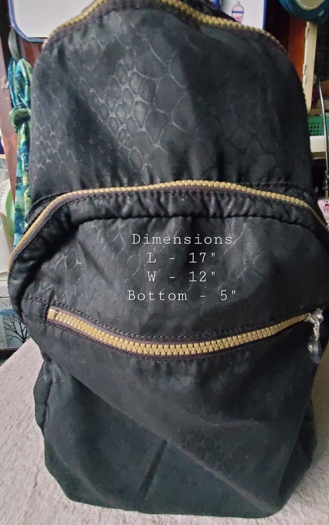 KIPLING BLACK BACKPACK (Category: Backpacks) located in Manila. Submitted by smicolen (Listing ID 1459630537, Image 1). Description: - Stylish black Kipling backpack - Multiple zippered compartments for organization - Interior lining with white polka dots and small monkey graphics - Adjustable, padded straps for maximum comfort - Approximate dimensions: Length 17", Width 12", Depth 5" ISSUES: ZIPPER NAG LOOSE SIYA KAYA MAY TAHI SA DULO NG ZIPPER.