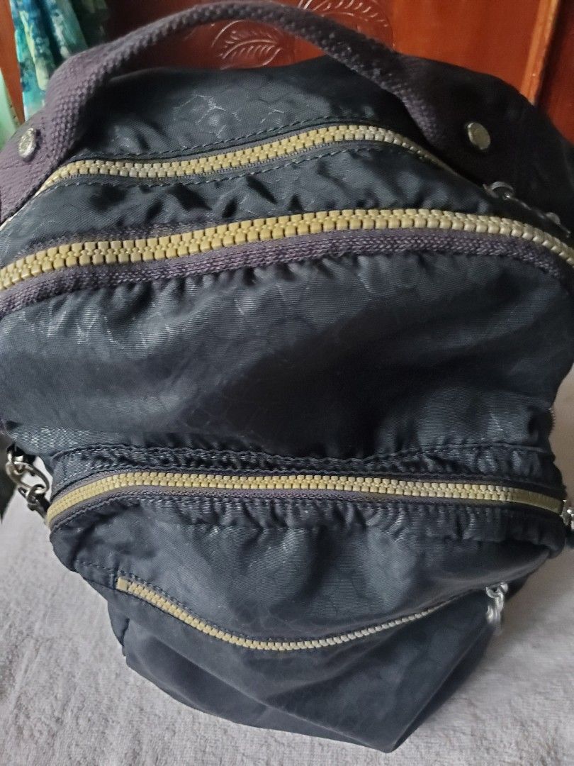 KIPLING BLACK BACKPACK (Category: Backpacks) located in Manila. Submitted by smicolen (Listing ID 1459630537, Image 2). Description: - Stylish black Kipling backpack - Multiple zippered compartments for organization - Interior lining with white polka dots and small monkey graphics - Adjustable, padded straps for maximum comfort - Approximate dimensions: Length 17", Width 12", Depth 5" ISSUES: ZIPPER NAG LOOSE SIYA KAYA MAY TAHI SA DULO NG ZIPPER.