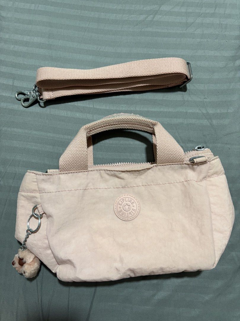 Kipling Pink Nylon Top Handle Bag with Shoulder Strap (Category: Cross-body Bags) located in Quezon City. Submitted by djmcderay (Listing ID 1459643217, Image 1). Description: - Adorable pink Kipling bag - Made from durable nylon material - Comfortable top handles - Detachable shoulder strap for versatility - Comes with the iconic fluffy monkey charm - Interior features a secure zippered pocket and a handy slip pocket - Smooth-gliding zippers - I