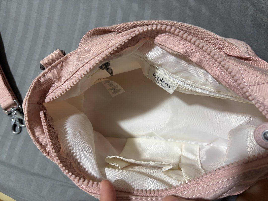 Kipling Pink Nylon Top Handle Bag with Shoulder Strap (Category: Cross-body Bags) located in Quezon City. Submitted by djmcderay (Listing ID 1459643217, Image 3). Description: - Adorable pink Kipling bag - Made from durable nylon material - Comfortable top handles - Detachable shoulder strap for versatility - Comes with the iconic fluffy monkey charm - Interior features a secure zippered pocket and a handy slip pocket - Smooth-gliding zippers - I