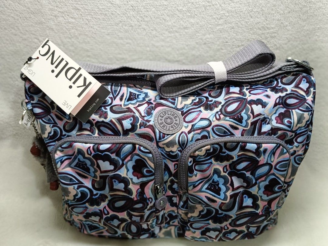 Kipling Sling Bag with Monkey Charm - Colorful Pattern (Category: Cross-body Bags) located in Quezon City. Submitted by shinereign (Listing ID 1459603409, Image 2). Description: - Cute Kipling sling bag - Fun, colorful paisley-like pattern - Multiple zippered pockets on the front - Includes signature Kipling monkey charm - Adjustable strap for comfortable wear - Ideal for everyday use.