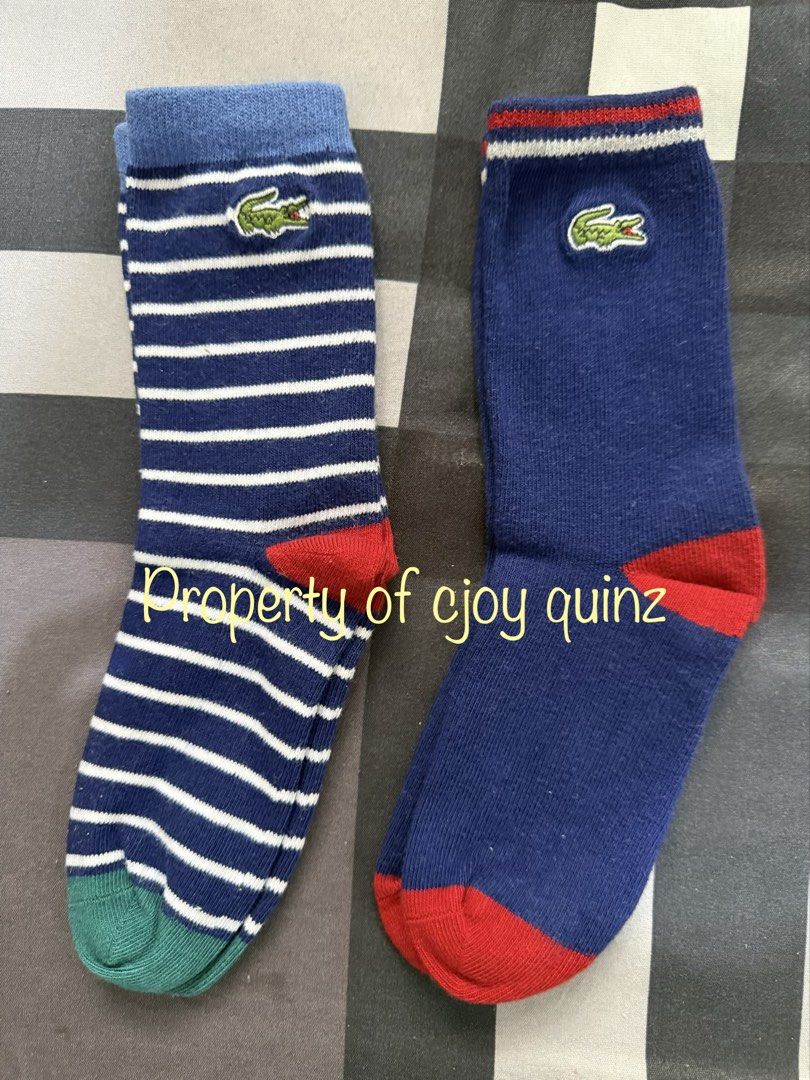 Lacoste Socks (2 Pairs) (Category: Babies & Kids Fashion) located in Muntinlupa City. Submitted by ceej_________9988 (Listing ID 1459610691, Image 1). Description: - Two pairs of authentic Lacoste socks - One pair: Navy with white stripes, red & green accents - Second pair: Solid navy with red accents - Features the iconic Lacoste crocodile logo - Ideal for everyday wear and comfort.