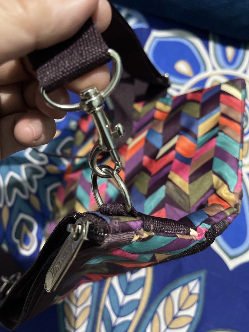 LeSportsac Pouch with Colorful Geometric Pattern (Category: Purses & Pouches) located in Manila. Submitted by edensy (Listing ID 1459640417, Image 2). Description: - Cute LeSportsac pouch with a vibrant geometric design. - Features multiple zippered compartments for excellent organization. - Adjustable strap allows for crossbody or shoulder wear. - Ideal for travel or carrying everyday essentials. - Zippers are smooth and functional. - Pouch is c