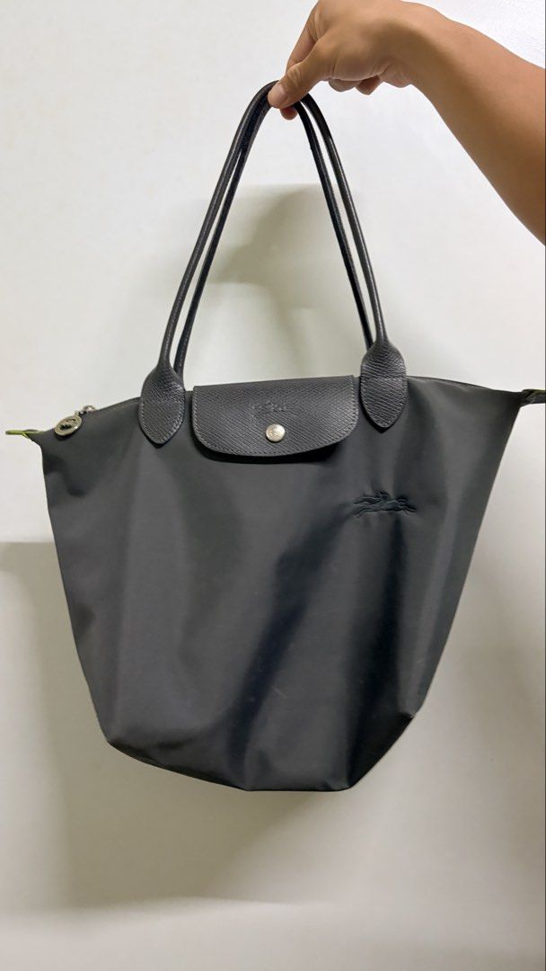 Longchamp Le Pliage Tote Bag (Category: Luxury Bags & Wallets) located in Manila. Submitted by ethrifts (Listing ID 1459513360, Image 2). Description: Longchamp Le Pliage Club Long Handle Tote • Large, spacious size • Black/dark graphite nylon with contrasting green details • Zip-top + snap closure • Exterior back pocket • Original Longchamp tag included Bought from Rustans Shang.