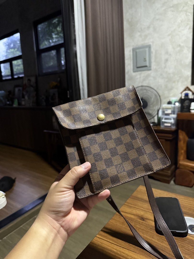 Louis Vuitton Damier Ebene Canvas Pochette (Category: Luxury Bags & Wallets) located in Manila. Submitted by jstspotsk (Listing ID 1459587892, Image 1). Description: - Authentic Louis Vuitton pouch - Damier Ebene canvas with classic checkered pattern - Compact size, ideal for essentials - Versatile: can be worn as a crossbody with a strap - Secure button closure on the flap - Perfect for everyday use or travel.