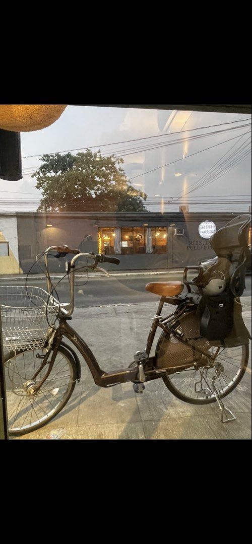 Mamachari Bike with Kid seat (Category: Bicycles) located in Mandaluyong City. Submitted by mariaelizaaa (Listing ID 1459546830, Image 1). Description: - Brown step-through Mamachari Bike (no pedal assist) - Large front basket for storage - OGK Japan Rear child seat included - Ideal for town rides, park trips, and parents with young children Rfs: Can no longer bike due to knee injury. Had fun bringing my toddler with me during bike rides..
