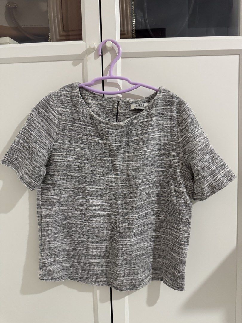 Mango Grey Textured Short Sleeve Top (Category: Blouses) located in Mangatarem. Submitted by jvleexx (Listing ID 1459626404, Image 1). Description: - Mango grey textured top - Short sleeves - Crew neckline - Zipper closure at the back - Unique textured fabric blend - Perfect for casual or dressed-up occasions.