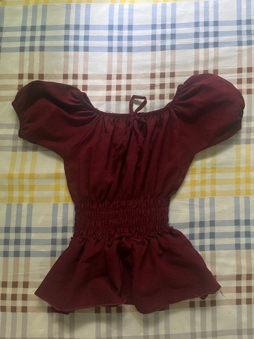 Maroon Off-Shoulder Smocked Peplum Top (Category: Blouses) located in Pakil. Submitted by jjeiikyu (Listing ID 1459537545, Image 1). Description: Cute maroon top. Off-shoulder design with puff sleeves. Smocked waist for a flattering fit. Peplum hem adds a nice flair. Tie detail at the neckline. Great for a casual day out or a night with friends..
