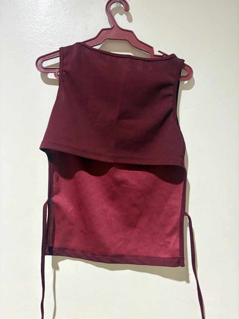 Maroon Sleeveless Tie-Back Crop Top (Category: Sleeveless) located in Manila. Submitted by gabriellea00749 (Listing ID 1459651753, Image 2). Description: - Sleeveless maroon crop top - Features adjustable tie-back details on the sides - Fabric has a subtle sheen - Versatile for casual outings or dressing up - Easy to pair with various bottoms - Message me for measurements -Price is still negotiable :).