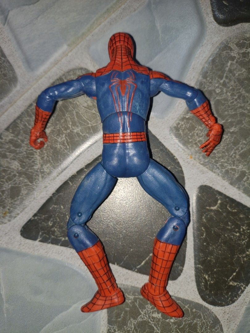 Marvel Spider-Man Action Figure 2014 (Category: Figurines & Statues) located in Narvacan. Submitted by picky_looter (Listing ID 1459634472, Image 3). Description: - Iconic Spider-Man action figure - Classic blue and red suit with web pattern - Approximately 6 inches tall - Features articulated joints for dynamic posing - Minor scuffing on the chest area - Made in China - Perfect for collectors and kids alike.
