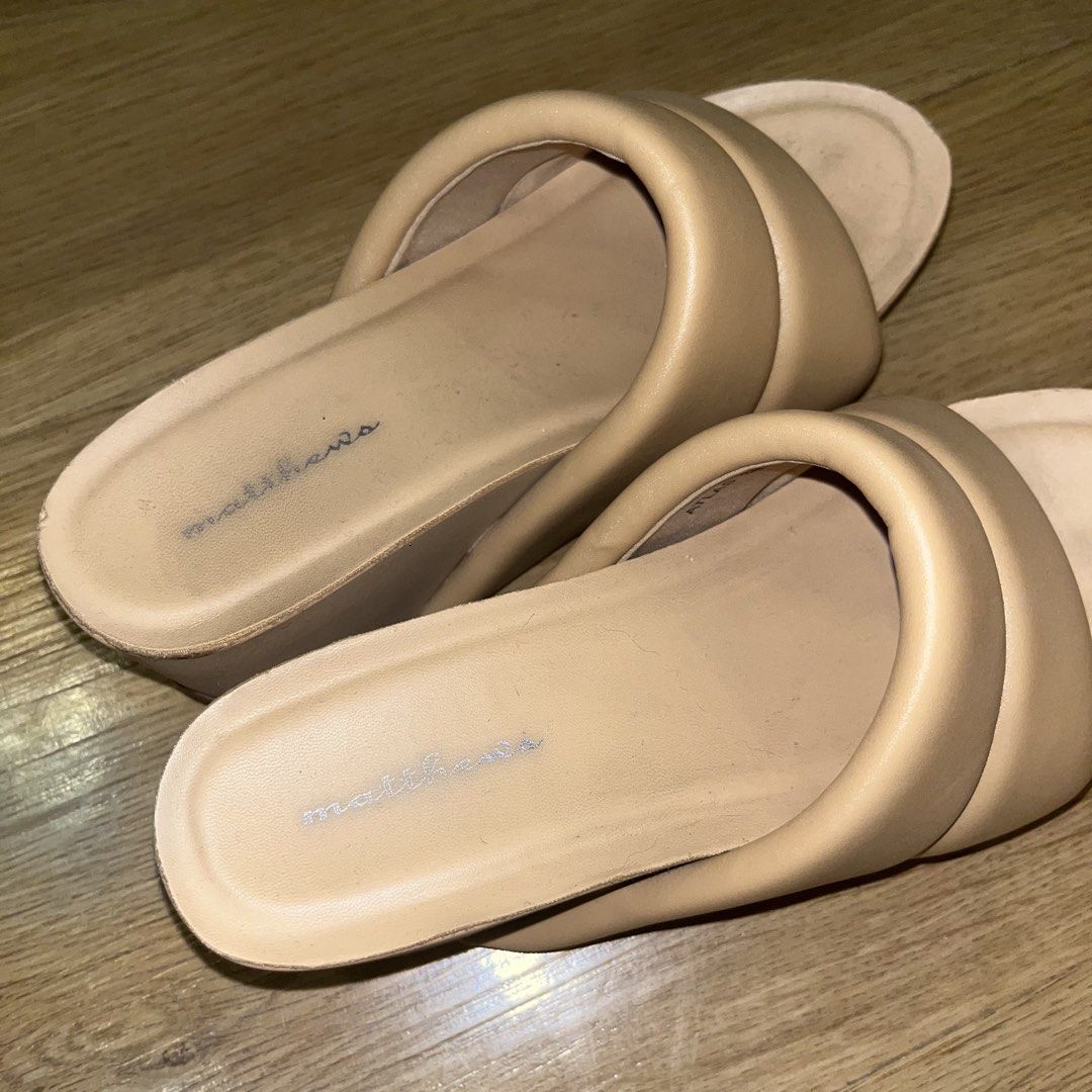 Matthews Padded Slides Sandals Beige (Category: Flats & Sandals) located in Paranaque City. Submitted by kalattt (Listing ID 1459546064, Image 3). Description: - Beige padded slide sandals from Matthews - Comfortable and easy slip-on design - Features a slight wedge heel for added height - Ideal for casual wear - Minor signs of wear on insoles (please check photos for details).