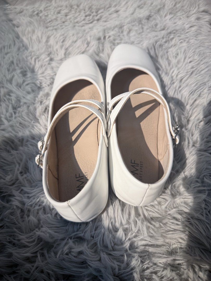 Meet My Feet White Flats Size 35 (Category: Flats & Sandals) located in Santo Tomas. Submitted by minimalistthriftshop (Listing ID 1459618690, Image 2). Description: - Classic white MMF shoes - Features a stylish square toe - Two adjustable straps with buckle closures for a secure fit - Comfortable for all-day wear - Ideal for school uniforms or special events - Easy to slip on and off.