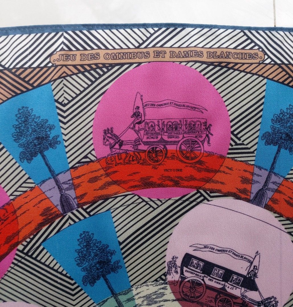 Melissa Silk Scarf (Category: Scarves) located in Lapu Lapu. Submitted by agnesapm_29813 (Listing ID 1459596003, Image 3). Description: - Features the 'Jeu des Omnibus et Dames Blanches' design - Vibrant colors and intricate patterns - Measurements: width-22 inches, height-22 inches - Versatile accessory to elevate any outfit - Ideal for collectors of fine scarves.
