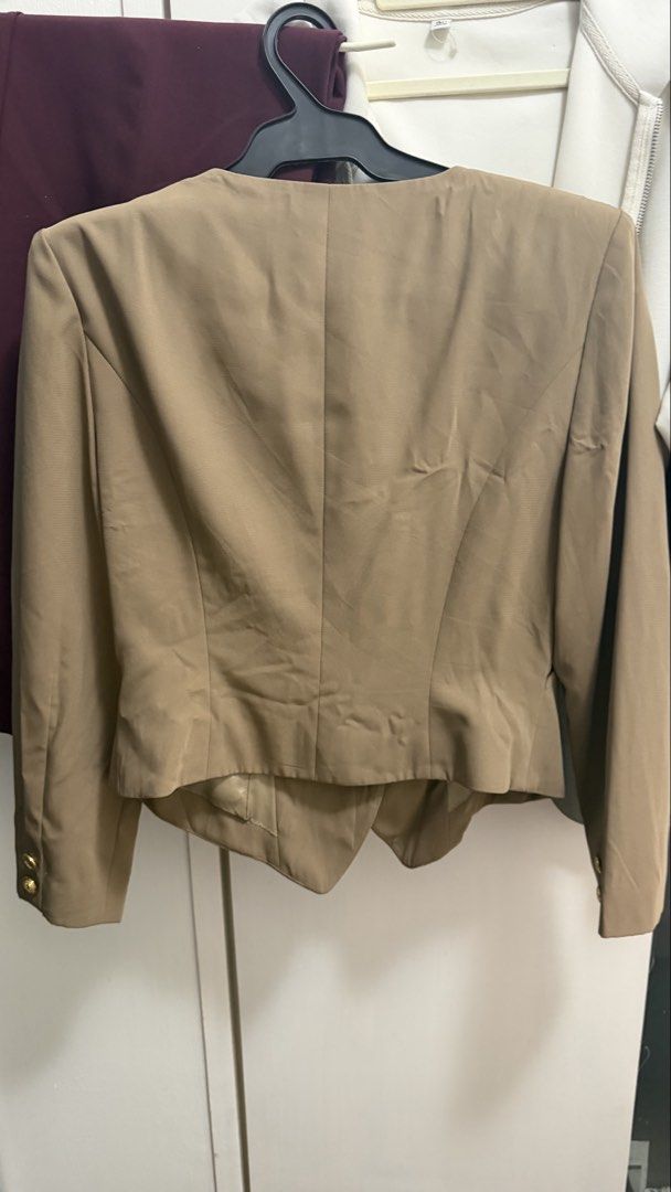 Melloweye Vintage Beige Button Blazer (Category: Coats, Jackets and Outerwear) located in Manila. Submitted by leean0924 (Listing ID 1459602432, Image 2). Description: - Beige blazer from Melloweye - Features elegant gold button details on front and cuffs - Structured fit with a classic notched lapel - Includes two front pockets and a chest pocket - Versatile for smart casual or office attire - Pairs well with trousers or skirts.