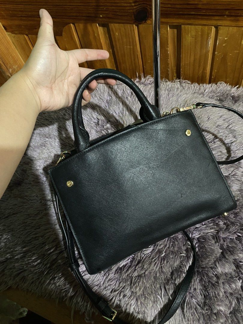 Michael Kors Black Leather Studded Satchel Handbag (Category: Luxury Bags & Wallets) located in La Trinidad. Submitted by kinleyky (Listing ID 1459617704, Image 3). Description: - Authentic Michael Kors satchel bag in classic black. - Crafted from premium textured leather. - Stylish gold stud details on the front. - Versatile carrying options: top handles and a detachable crossbody strap. - Secure zipper closure to keep your belongings safe. - Am