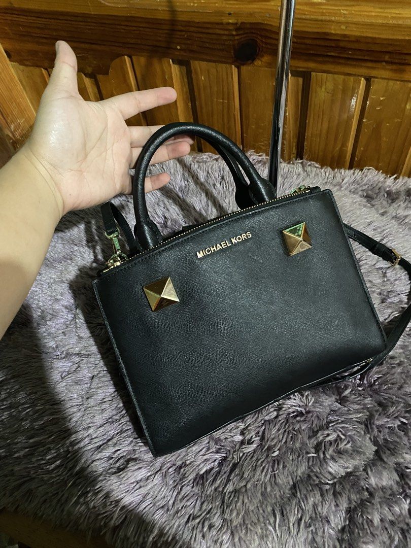 Michael Kors Black Leather Studded Satchel Handbag (Category: Luxury Bags & Wallets) located in La Trinidad. Submitted by kinleyky (Listing ID 1459617704, Image 2). Description: - Authentic Michael Kors satchel bag in classic black. - Crafted from premium textured leather. - Stylish gold stud details on the front. - Versatile carrying options: top handles and a detachable crossbody strap. - Secure zipper closure to keep your belongings safe. - Am