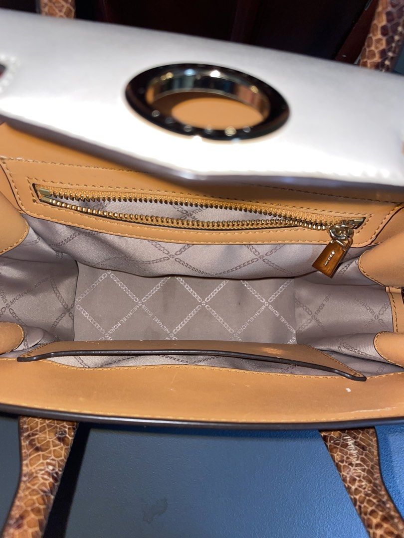 Michael Kors Leather & Snakeskin Trim Handbag (Category: Luxury Bags & Wallets) located in Las Pinas. Submitted by gabriel0123 (Listing ID 1459647943, Image 3). Description: - Bought for 10k - Genuine tan leather handbag - Chic white and snakeskin trim - Prominent Michael Kors logo on the front - Interior zip pocket for essentials - Spacious main compartment - Includes a stylish chain strap - Ideal for everyday wear or evening events - May Stains