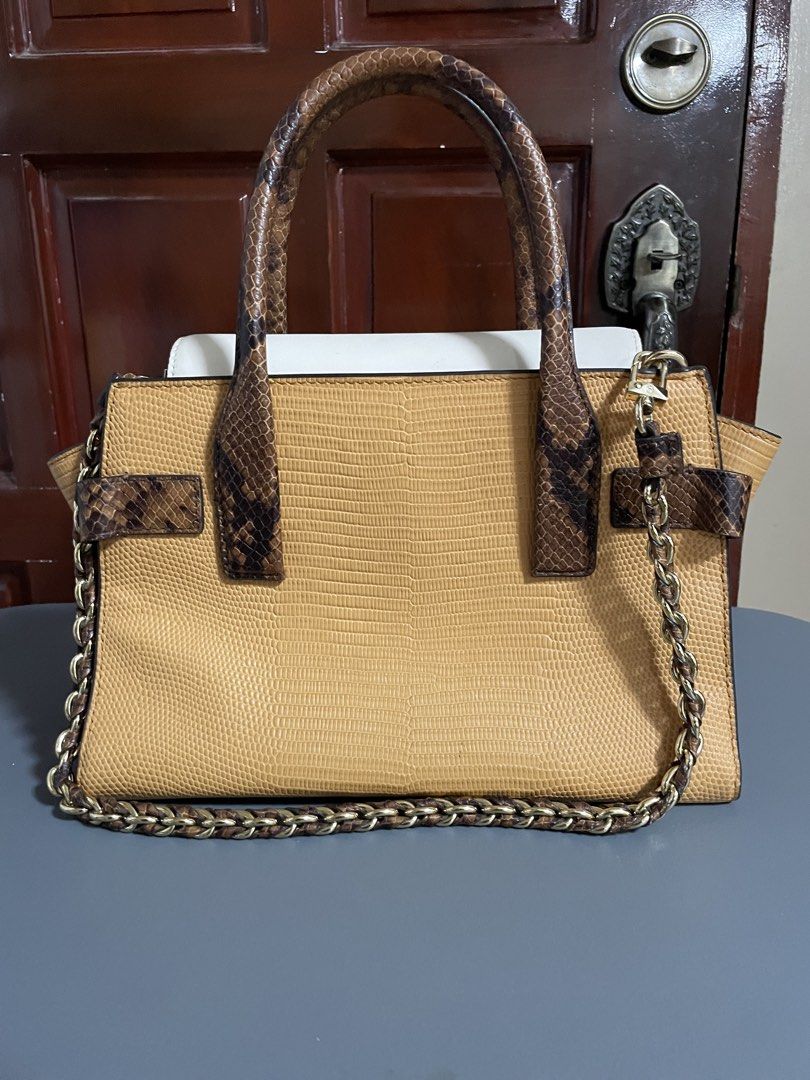 Michael Kors Leather & Snakeskin Trim Handbag (Category: Luxury Bags & Wallets) located in Las Pinas. Submitted by gabriel0123 (Listing ID 1459647943, Image 2). Description: - Bought for 10k - Genuine tan leather handbag - Chic white and snakeskin trim - Prominent Michael Kors logo on the front - Interior zip pocket for essentials - Spacious main compartment - Includes a stylish chain strap - Ideal for everyday wear or evening events - May Stains