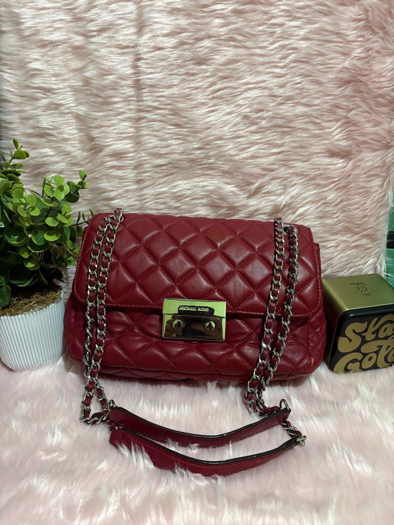 Michael Kors Quilted Leather Chain Shoulder Bag Red (Category: Shoulder Bags) located in Tuguegarao City. Submitted by closet_jz (Listing ID 1459503913, Image 2). Description: - Michael Kors quilted leather shoulder bag - Deep red color - Silver hardware - Turn-lock closure - Chain strap - Minor scuffs on bottom corners - Clean interior - Ideal for everyday use Issue: small black stain Slight peel as shown in the pic very minor.