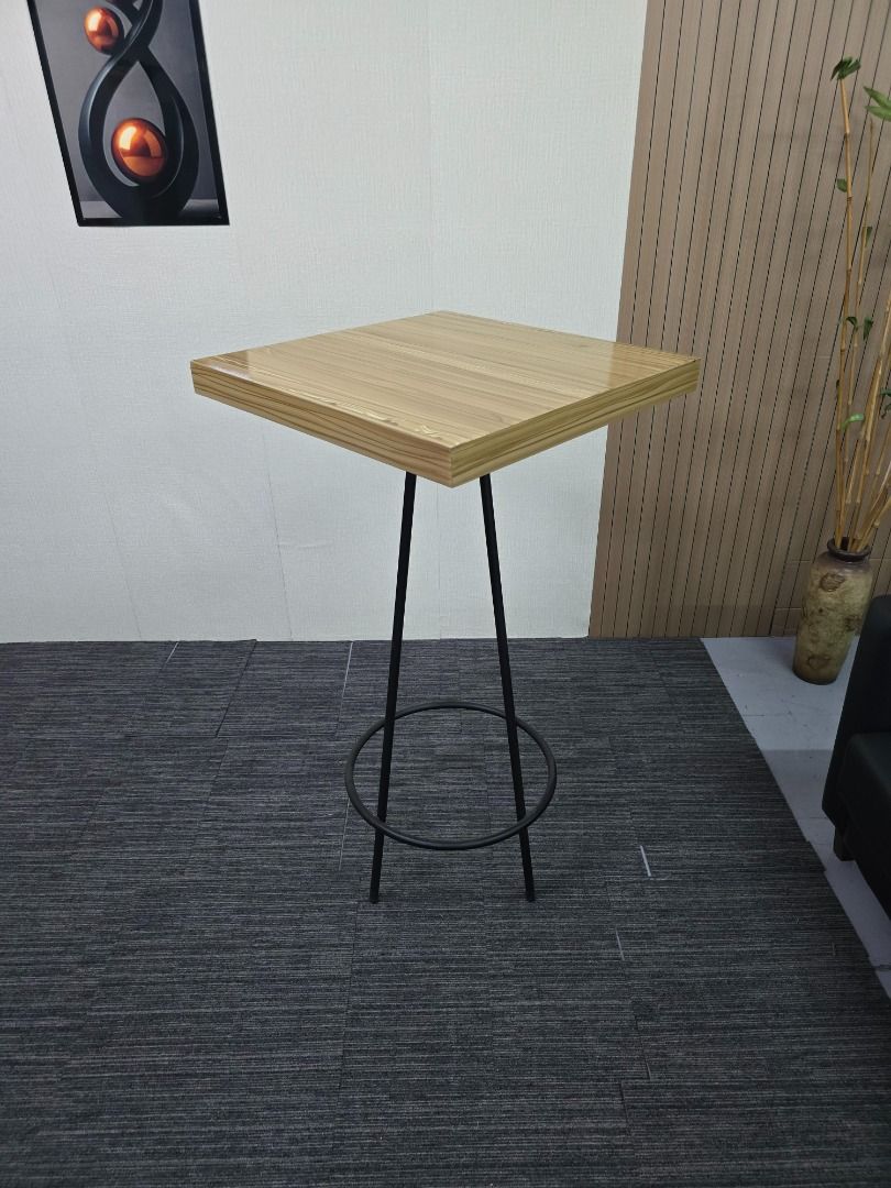 Modern Square Top Bar Table with Black Metal Legs (Category: Tables & Sets) located in Quezon City. Submitted by kevinmacabata12997160 (Listing ID 1459542489, Image 3). Description: - Stylish bar table - Light wood grain square top - Sturdy black metal legs with circular footrest - Ideal for small dining areas or as a standing desk - Minimalist design complements any decor - Easy to clean surface.