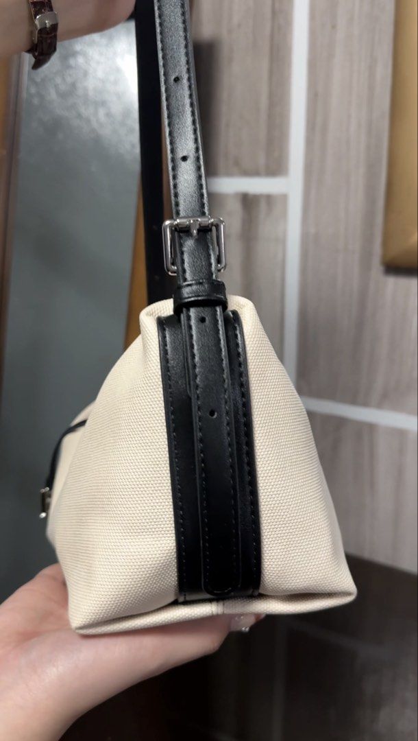 Mossdoom Canvas Shoulder Bag (Category: Shoulder Bags) located in Manila. Submitted by maudmd (Listing ID 1459635351, Image 2). Description: - Cream canvas shoulder bag - Black leather accents - Zipper closure - Adjustable strap - Metal 'M' logo charm - 'MOSS DOOM' embossed on the side - Clean and simple design - Great for everyday use.