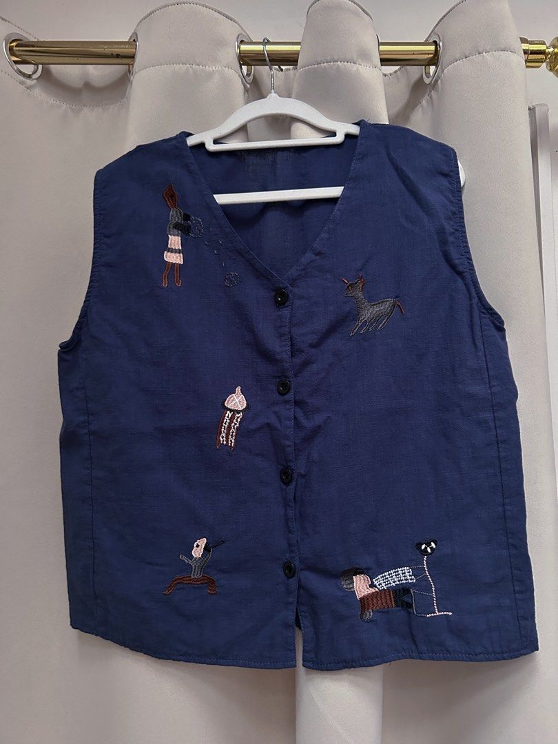 Navy Blue Embroidered Vest (Category: Others Tops) located in Cainta. Submitted by unboxingstuff (Listing ID 1459621651, Image 1). Description: - blue sleeveless linen vest - Features unique embroidery of animals and people - Classic button-up front design - Perfect for layering over any outfit - Estimated size M-L for comfortable fit.