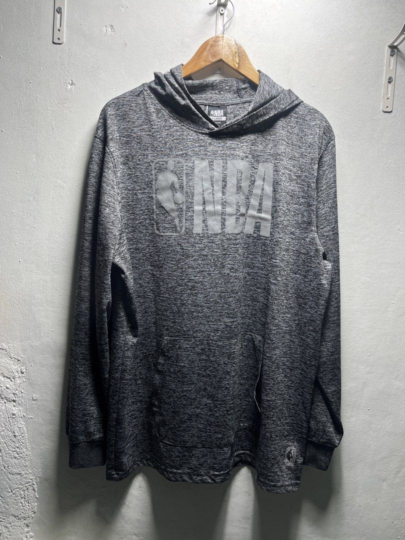 NBA Grey Heathered Reflective Hoodie (Category: Hoodies) located in Pasig City. Submitted by thrift2mnl (Listing ID 1459616825, Image 1). Description: - Grey heathered NBA hoodie - Features iconic NBA logo graphic on the front - Long sleeves with ribbed cuffs - Hooded design - Size: X-Large - Ideal for casual wear or NBA fans.