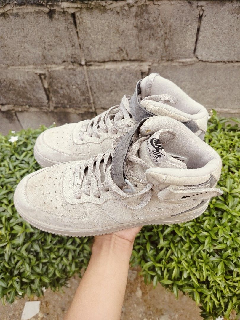 Nike Air Force 1 High Top Suede Sneakers (Category: Sneakers) located in Davao. Submitted by urhandsome_hb (Listing ID 1459566237, Image 2). Description: - Nike Air Force 1 High x Reigning Champ - Color: Light beige/grey suede - Classic Air Force 1 silhouette - Features a velcro ankle strap - Nike Air logo on tongue and heel - Perfect for everyday casual wear.